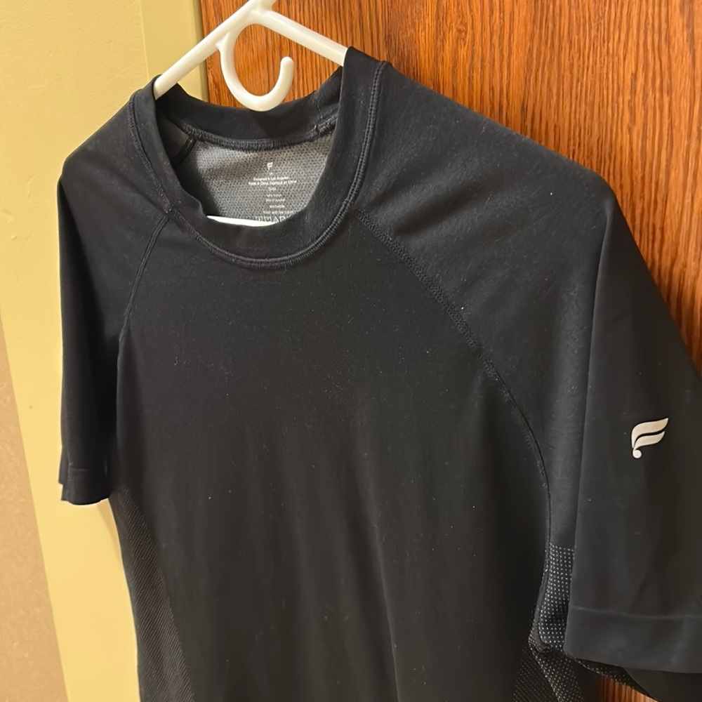 Black Fabletics athletic shirt. Size M. Was too small, barely worn.
